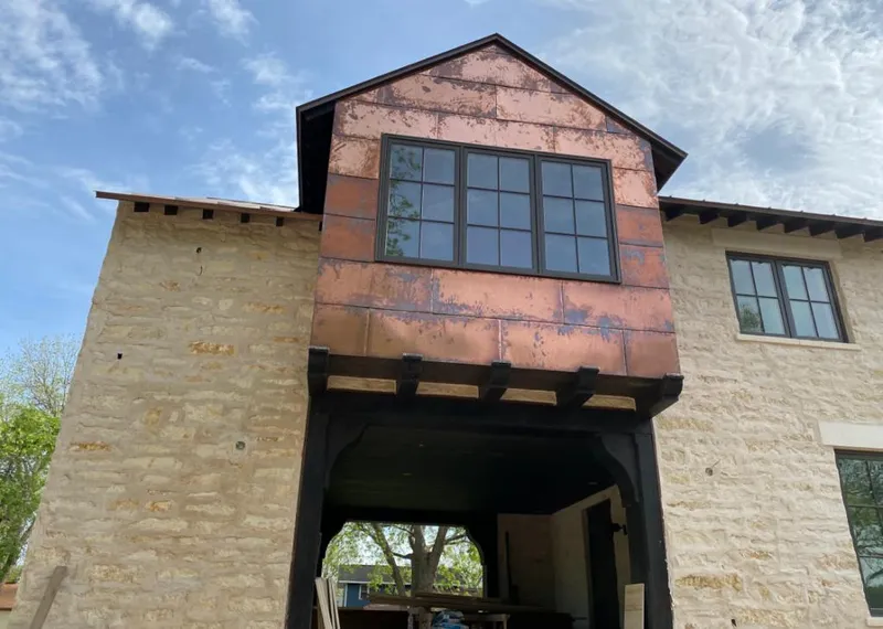 Copper metal panel facade on a stone building for Skylight Installation in Valdosta