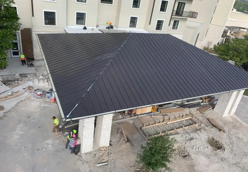 Metal roofing installation team working on a commercial building in Valdosta